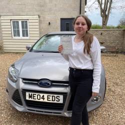 Woman holding driver's licence near car, ME04 EDS.