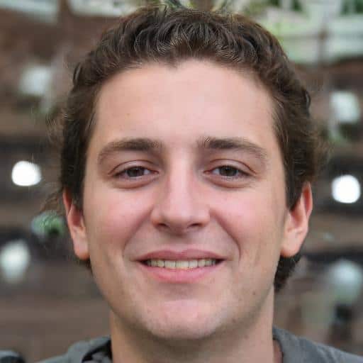 Smiling person with short curly hair.