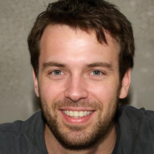 Smiling man with beard and dark hair
